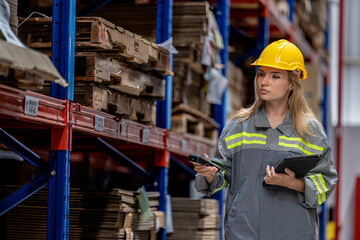 woman worker walking and checking stock items for shipping. Female inspecting the store factory....