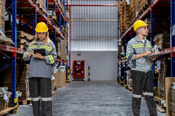 workers walking and checking stock items for shipping. male and female inspecting the store factory. Logistics employees holding folders at on site warehouse area for shipping transportation.