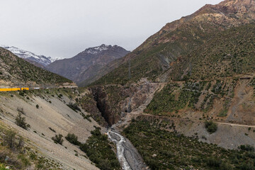 Fototapeta premium A freezing day high in the Andes Mountains in Chile, with mountains covered in snow.