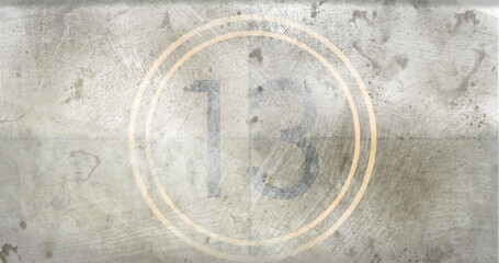 Number 13 displayed in center of weathered, gray background