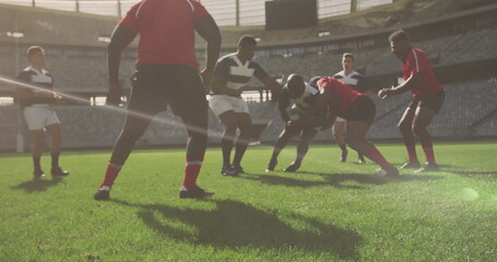 Image of glowing lights over diverse rugby players in sports stadium