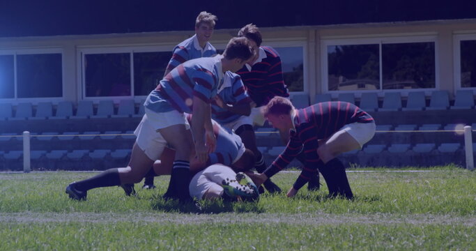 Image of glowing lights over diverse rugby players in sports stadium