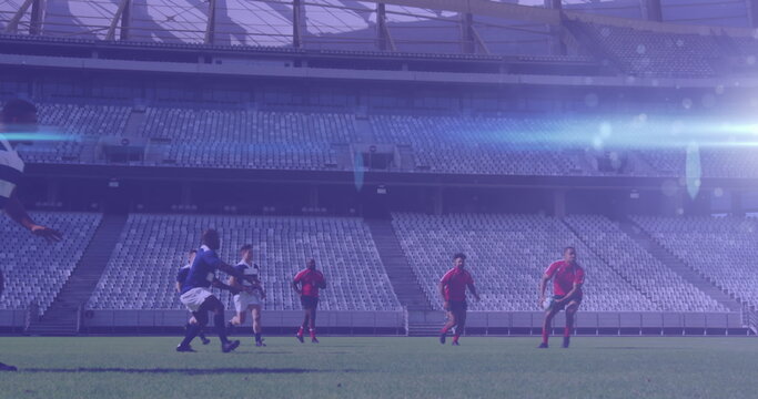 Image of glowing lights over diverse rugby players in sports stadium