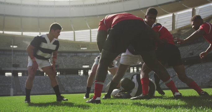 Image of glowing lights over diverse rugby players in sports stadium