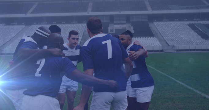 Image of glowing lights over diverse rugby players in sports stadium