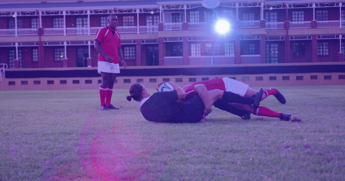 Image of glowing lights over diverse rugby players in sports stadium