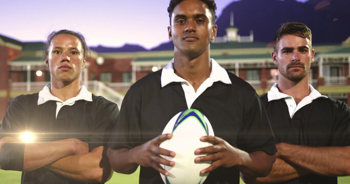Image of glowing lights over diverse rugby players in sports stadium