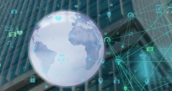 Image of globe and connected icons over low angle view of building