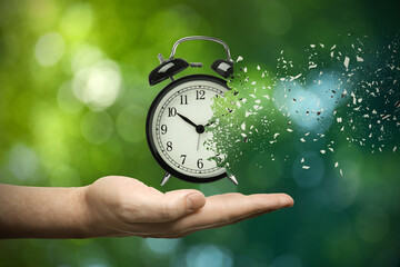 Time running out. Man with dissolving alarm clock on blurred background, closeup