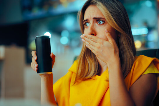 Woman Having a Soda Drink Burping from Gas Bubbles. Customer in a restaurant having a carbonated beverage
