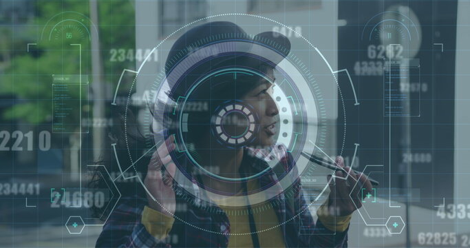 Image of round scanner and changing numbers over asian woman talking on smartphone on the street - Powered by Adobe