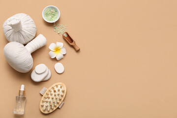 Herbal bags, spa stones, massage body brush, bottle of cosmetic product and bowl with sea salt on beige background