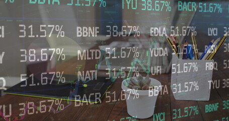 Image of financial data processing over office desk with laptops and tablet