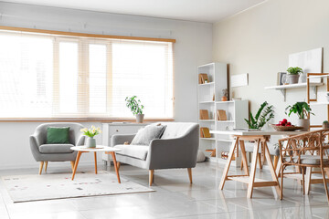 Interior of stylish living room with sofa, coffee table, carpet and window