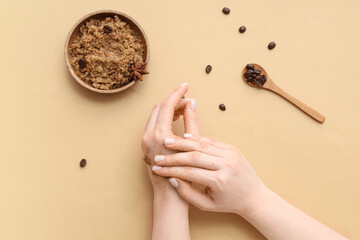 Female hands with coffee body scrub on color background, closeup