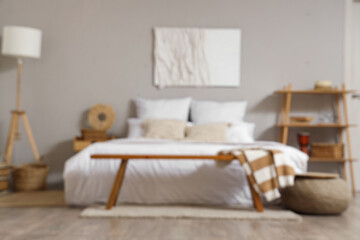 Stylish interior of bedroom with picture on wall
