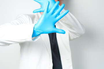 Stop gesture, arms crossed in blue gloves, sign protest, rejection, on white background