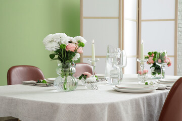 Festive table setting for wedding near green wall in dining room