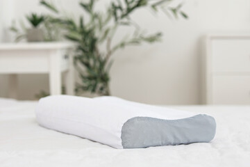 Soft orthopedic pillow on bed in room