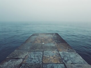 A gray and blue ocean with a pier in the middle. The pier is empty and the water is calm,Back drop photo with a calm sea background - Powered by Adobe