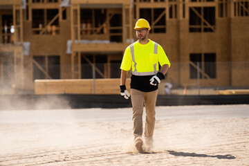 A construction worker in highvisibility gear emphasizes safety and professionalism at a dusty work...
