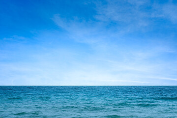 Ocean background and sea water and clear sky. For summer vacation ideas The nature of the beach and summer sea with the sun shining on the sea sparkling against the blue sky.