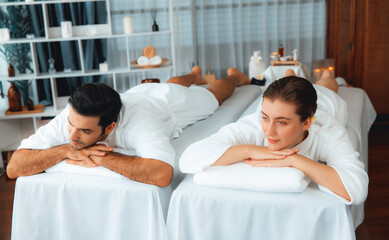 Caucasian couple customer enjoying relaxing anti-stress spa massage and pampering with beauty skin...