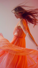 A woman in a long orange dress is dancing in the air