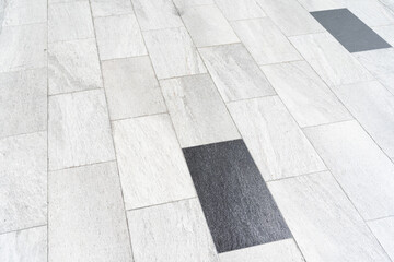 White tiles floor in perspective view. Clean and asymmetry surface with grid texture background.
