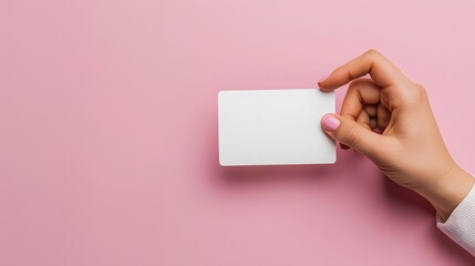 Hand holding an empty white card on a pink background, representing the concept of AI-generated humorous ID cards for business or personal use.