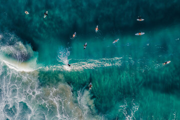 Aerial view of surfers riding a wave in the ocean, Gold Coast, Australia