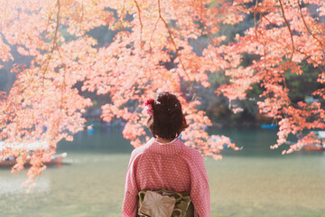 Woman in Kimono in Arashiyama in Autumn in Kyoto, Japan