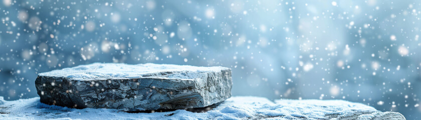 Snow-covered stone slab during a gentle snowfall, creating a serene winter scene with a soft background of falling snowflakes.