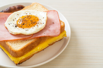bread toasted cheese topped ham and fried egg with pork sausage