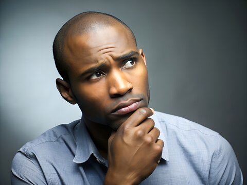 A Young Man With A Thoughtful Expression On His Face Is Looking Up.