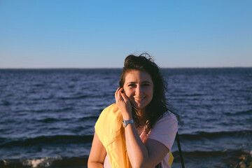 Portrait of beautiful brown-haired woman on background of sea