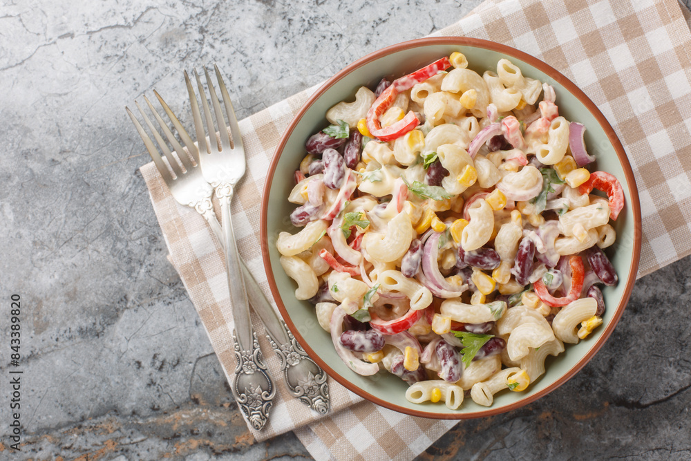 Wall mural southwestern elbow pasta salad filled with fresh veggies, red beans, and a zesty dressing close up o