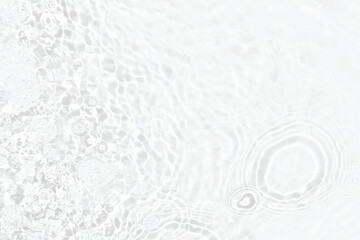 White water with ripples on the surface. Defocus blurred transparent white colored clear calm water surface texture with splashes and bubbles. Water waves with shining pattern texture background.