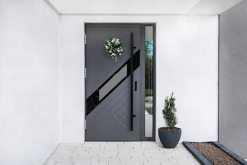 Designer entrance door to a country house. Modern design. Luxurious exterior. Facade of a modern...