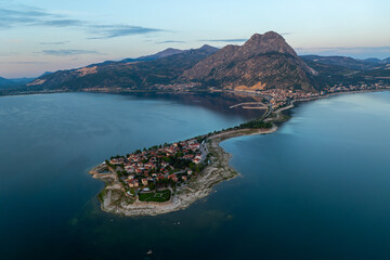 Fototapeta premium Aerial view of Egirdir town in Turkey. A small turkish town in the middle of the giant lake under the mountains.