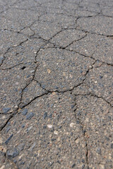a part of a highway covered with cracked asphalt