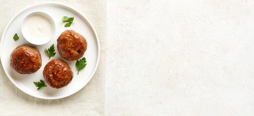 Minced pork and beef cutlets with sauce on plate on white background