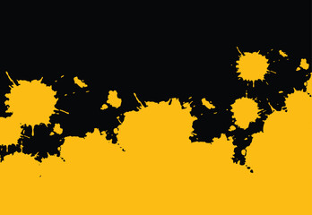 Yellow abstract paint splatter on black background