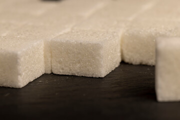 white square sugar on a black background