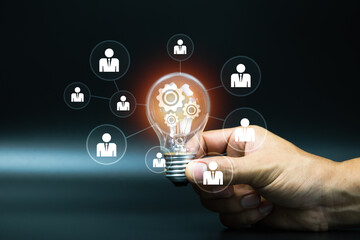 Hand choose light bulb with person HR human resources icon for personal leader training skill or leadership and business team creative thinking and organization management teamwork or team player.