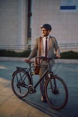 Happy entrepreneur commuting to work by bike and looking away.