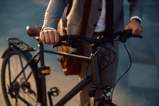 Close up of businessman with bicycle on street.