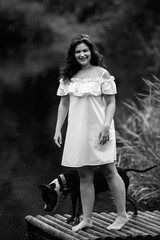 A young beautiful girl swims in a pond. Black and white photo.
