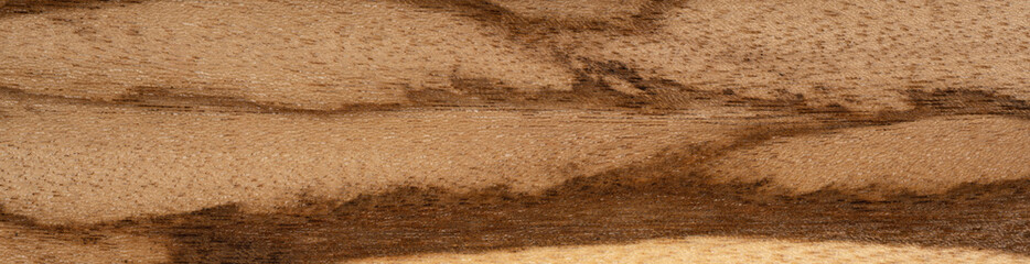 A close up of a piece of antique wooden surface. Panoramic wood veneer texture.