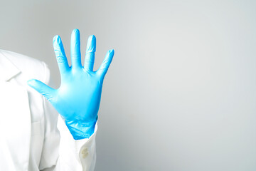 hand gestures or signs in blue disposable latex surgical gloves isolated